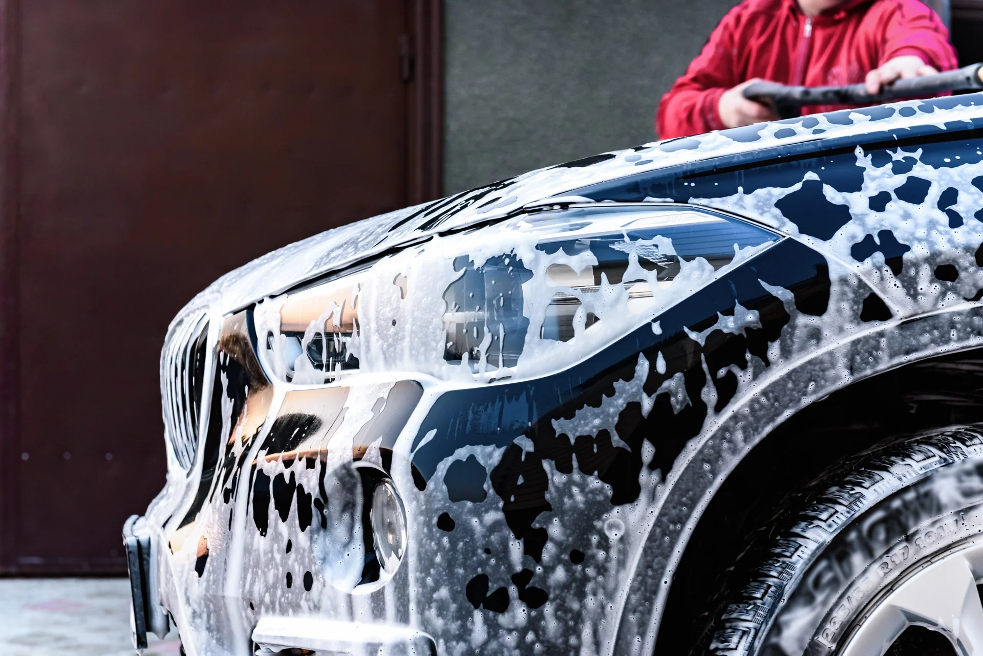 A car covered in wash foam